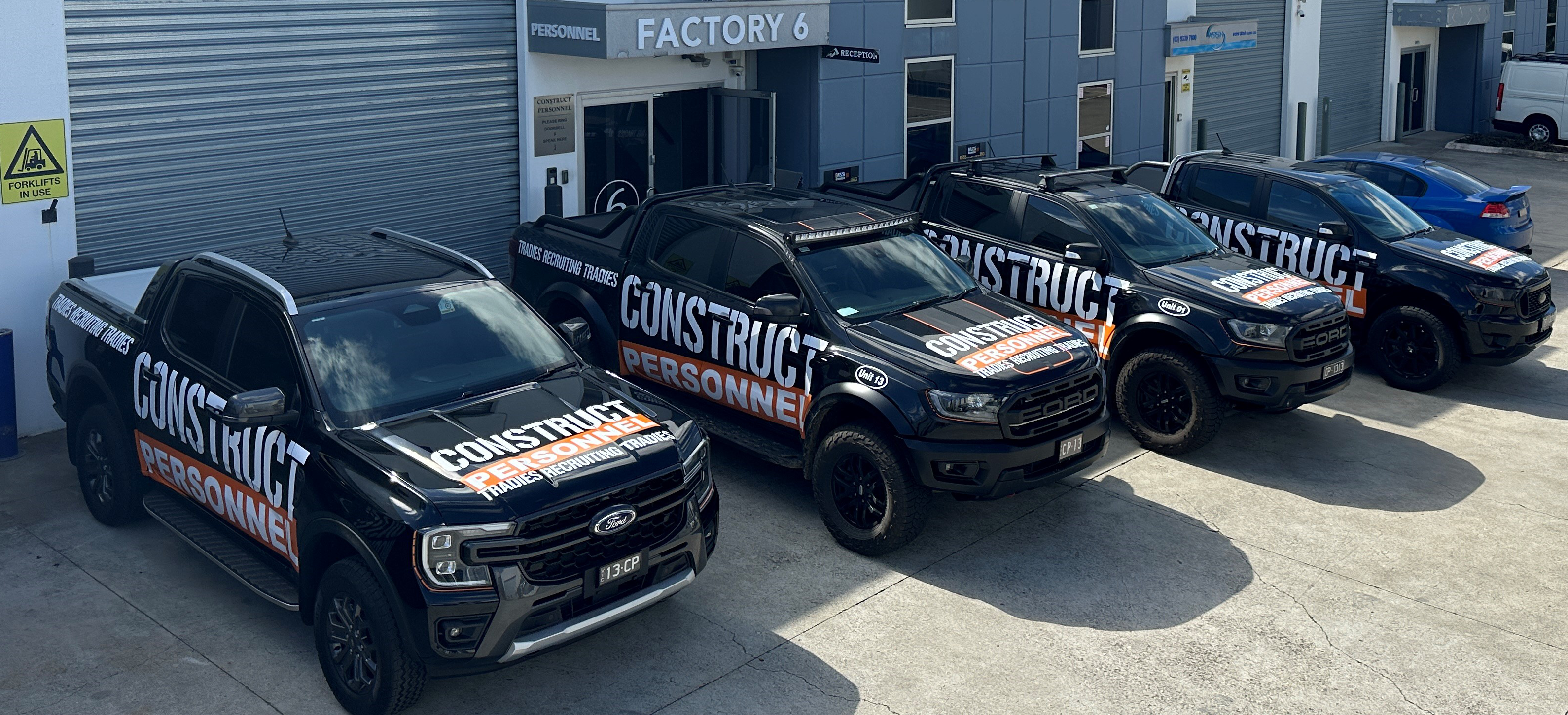 Branded Construct Personnel company fleet parked parked in front of Construct Personnel Office..